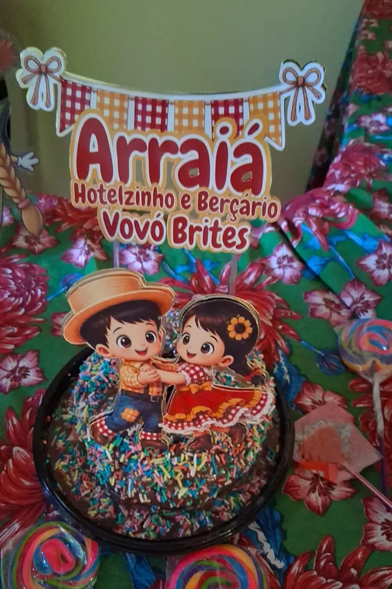 Crianças comemorando o São João com mesa decorada